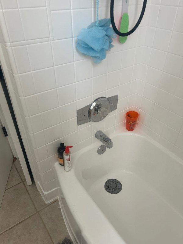 Completed on-site assessment of residential bathroom plumbing system for piping estimate. Inspected bathtub/shower area with existing chrome fixtures and standard alcove configuration, as well as under-sink plumbing including PVC drain assembly, braided supply lines, and shut-off valves. Documented current conditions and photographed all relevant plumbing components to provide accurate piping estimate for requested work.