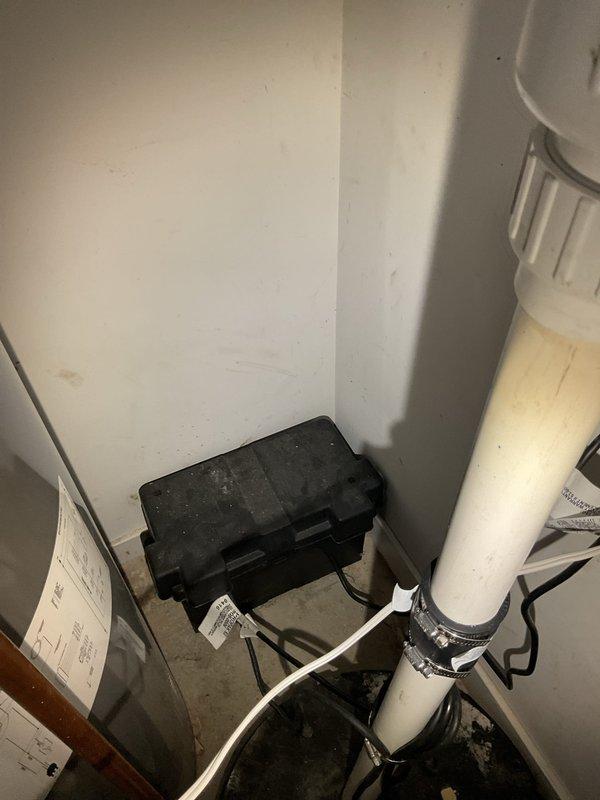 Responded to service call for non-functional sump pump backup battery system following recent power outage. Upon arrival, inspected downstairs utility space and confirmed backup battery failure in 20-year-old residential sump pump installation. 

Disconnected existing automotive-style battery from system, removing corroded terminal connections and associated wiring harnesses. Verified sump pump primary operation and float switch functionality. Installed new replacement backup battery per customer request, reconnecting all power cables and terminal rings to proper polarity. Tested battery charging circuit and verified system integration with existing sump pump controller. Confirmed backup power system now operational and ready for next power interruption event.