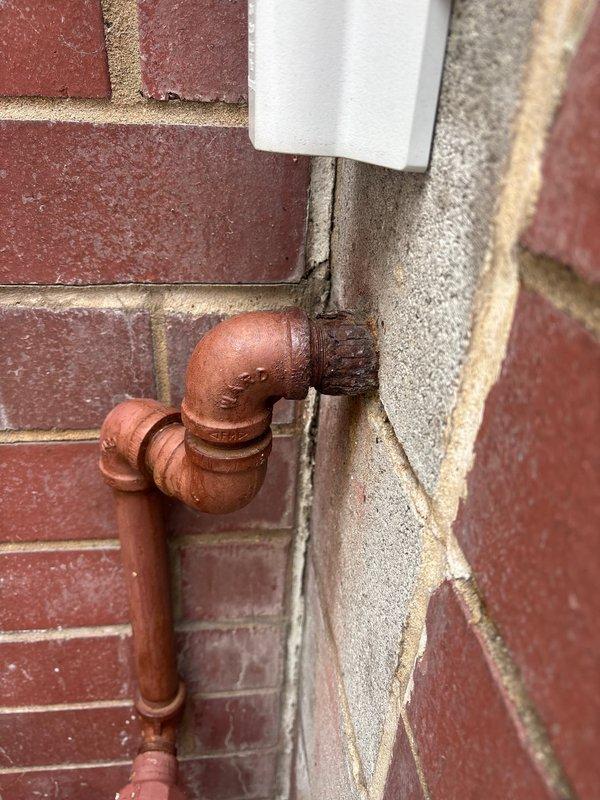 Responded to gas leak call near meter location. Upon inspection, identified active gas leak in heavily corroded piping system at exterior meter connection point. Copper piping exhibited significant weathering and oxidation with brownish-red patina throughout multiple joints and fittings. Interior gas piping showed extensive rust corrosion on vertical and horizontal runs, with deteriorated conditions present on brown pipe sections and fittings near gas shutoff valve. Documented conditions with photographs showing compromised pipe integrity at multiple connection points including 90-degree elbows and solder joints. Recommended complete replacement of corroded gas piping system due to safety concerns and extent of deterioration. Provided estimate for necessary repairs to eliminate leak hazard and restore system to code compliance.