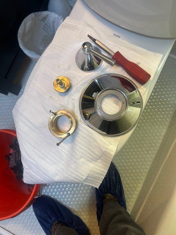 Responded to service call for excessive noise occurring during temperature adjustment at bathtub/shower fixture. Upon inspection, identified worn internal valve components causing water hammer and vibration when mixing hot and cold water. Disassembled shower valve assembly, removing chrome escutcheon plate, handle trim, and cartridge housing. Replaced deteriorated brass valve seats and internal cartridge mechanism. Cleaned all mating surfaces and reinstalled components with proper sealing. Tested fixture operation through full range of temperature adjustment to verify elimination of noise and confirm smooth operation. All chrome trim reinstalled and fixture returned to normal function.