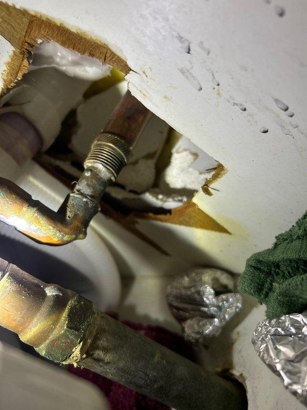 Responded to emergency plumbing call involving flooding from outdoor spigot that caused water damage to kitchen and basement. Inspected and repaired copper supply line connections and brass fittings at spigot penetration point through exterior wall. Addressed multiple fixture issues in downstairs bathroom including restoration of hot water supply to shower and repair of non-functioning cold water valve at bathroom faucet. Verified proper operation of all affected fixtures and confirmed no active leaks at repaired connections.