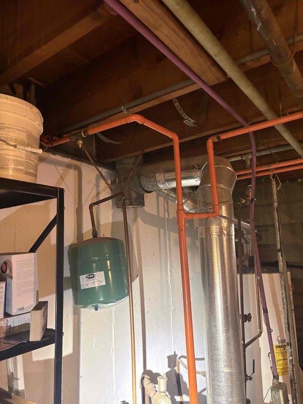 Conducted on-site assessment for boiler replacement serving radiant heating system in residential property. Documented existing mechanical infrastructure including water heater, expansion tank, PEX distribution lines, copper piping, and associated HVAC components in unfinished basement utility area to prepare comprehensive replacement estimate.