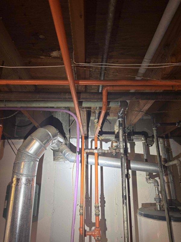 Conducted on-site assessment for boiler replacement serving radiant heating system in residential property. Documented existing mechanical infrastructure including water heater, expansion tank, PEX distribution lines, copper piping, and associated HVAC components in unfinished basement utility area to prepare comprehensive replacement estimate.