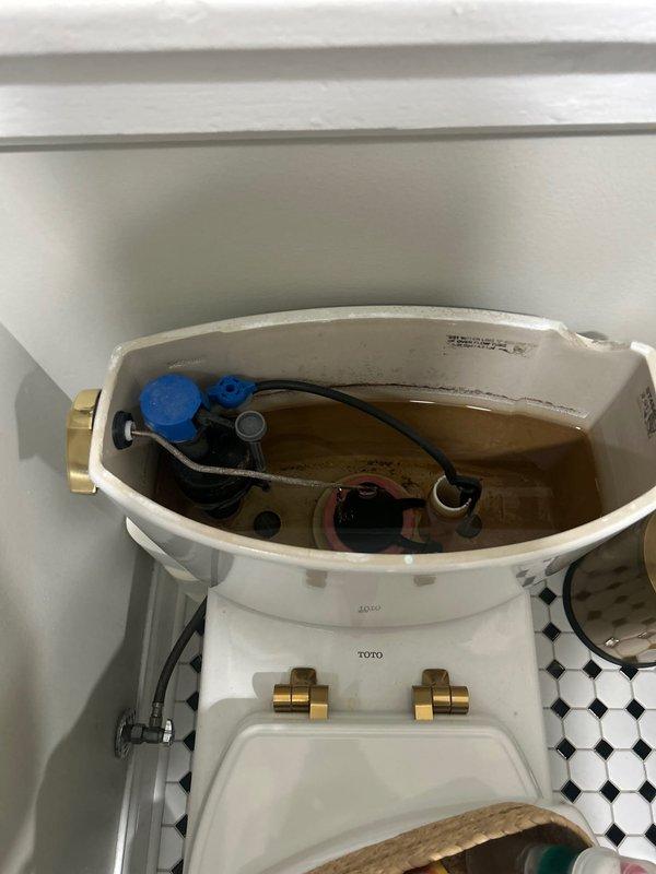 Completed toilet rebuild on TOTO brand fixture, including disassembly of tank components, inspection of internal flushing mechanism, and replacement of worn flush valve assembly with float valve system. Addressed mineral deposits and water staining found throughout tank interior, replaced deteriorated rubber flappers and connecting hardware, and performed camera inspection of drain line to verify proper function and rule out downstream blockages.