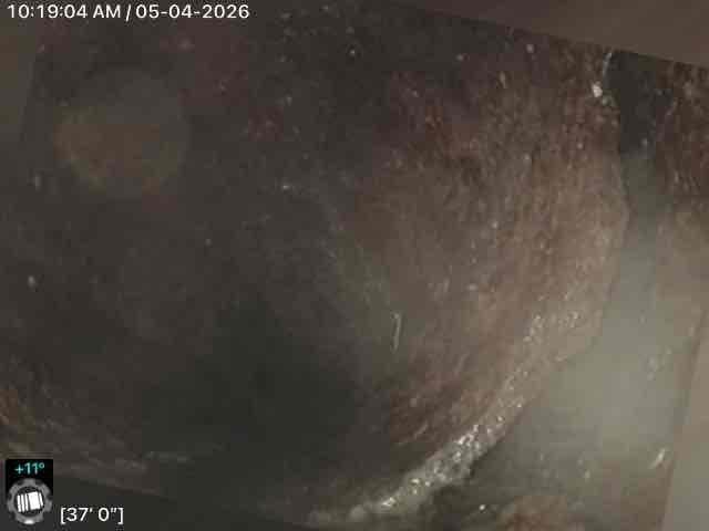 Conducted video inspection of main sewer line to assess interior condition and identify any defects or obstructions. Camera inspection revealed significant aging, corrosion, and buildup throughout the line extending from 37 feet to 54 feet, with visible discoloration, rust deposits, and deteriorated metal banding within the pipe structure.