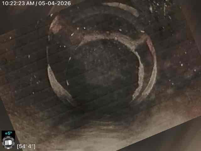 Conducted video inspection of main sewer line to assess interior condition and identify any defects or obstructions. Camera inspection revealed significant aging, corrosion, and buildup throughout the line extending from 37 feet to 54 feet, with visible discoloration, rust deposits, and deteriorated metal banding within the pipe structure.