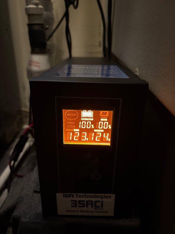 Responded to service call for banging noise originating from sump pump system. Upon arrival, inspected the iOn Technologies 35ACI Battery Backup System and found the unit displaying operational readings but exhibiting signs of potential battery failure. Evaluated the complete sump pump installation including primary pump, discharge piping, check valve assembly, and backup power system. Discussed with property owner the comparative benefits and longevity expectations between full system replacement versus component-level repair of the battery backup unit. Documented existing equipment configuration including PVC discharge lines, electrical connections, and control panel setup through photographic records for reference and future maintenance planning.