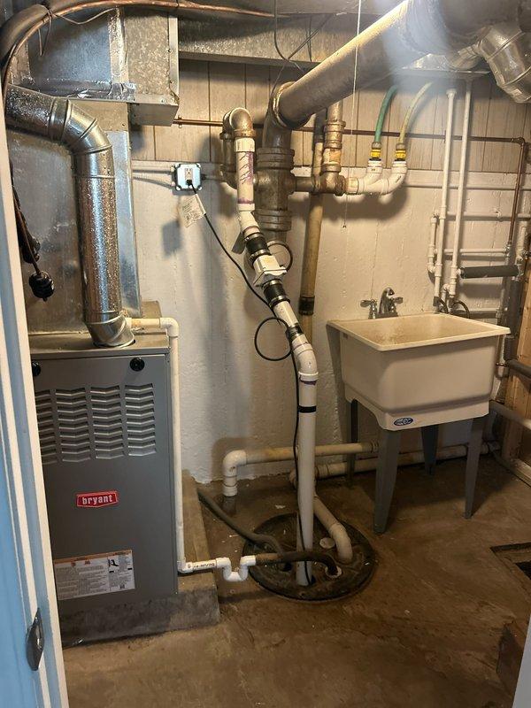 Conducted comprehensive inspection of residential plumbing system focusing on pump equipment and existing galvanized piping infrastructure. Evaluated basement mechanical room containing water supply lines, noting configuration of copper and PVC piping systems alongside aging galvanized steel components. Assessed condition of vertical pipe runs, connections, and overall water distribution network. Documented HVAC integration points where plumbing interfaces with heating system ductwork. Inspected recently renovated bathroom plumbing, including supply lines serving vanity sink, toilet, and bathtub/shower fixture. Photographed existing galvanized pipe sections identified for removal and replacement to prevent further corrosion and potential water quality issues. Provided estimate for galvanized pipe removal and modern piping system installation.