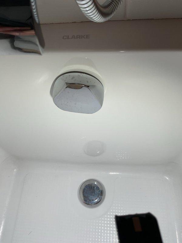 Responded to a clogged shower drain service call. Upon inspection, identified blockage in the shower drain line and successfully cleared the obstruction to restore proper drainage. Documented existing plumbing fixtures including bathtub overflow assembly and drain components, confirming all fixtures were functioning properly after clearing the clog.