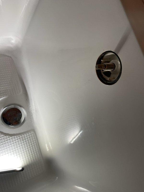 Responded to a clogged shower drain service call. Upon inspection, identified blockage in the shower drain line and successfully cleared the obstruction to restore proper drainage. Documented existing plumbing fixtures including bathtub overflow assembly and drain components, confirming all fixtures were functioning properly after clearing the clog.