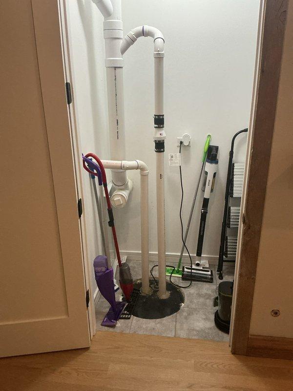 Responded to a morning appointment for resealing pipes in a residential sewer ejector system. Upon arrival, inspected the utility closet housing the ejector pump assembly and identified multiple white PVC pipes requiring attention. The vertical drainage pipes showed signs of potential seal deterioration at black rubber coupling connectors. Performed resealing work on the pipe connections within the sewer ejector system to prevent future leaks and ensure proper wastewater evacuation. Documented the existing pipe configuration, including various elbows, fittings, and vertical runs, noting dark staining on the tile floor near the base of the pipe assembly indicating previous moisture issues. Completed necessary sealing repairs to restore system integrity and prevent wastewater seepage.
