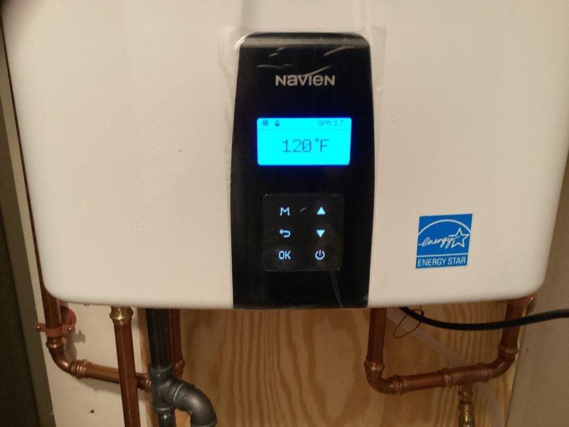 Completed VIP maintenance service on a Navien tankless water heater system. Performed comprehensive inspection of the unit, verified operational status with display reading 120°F, checked all control panel functions, and inspected copper piping connections and valving at the water inlet/outlet points. All components found to be functioning properly with Energy Star certification intact.