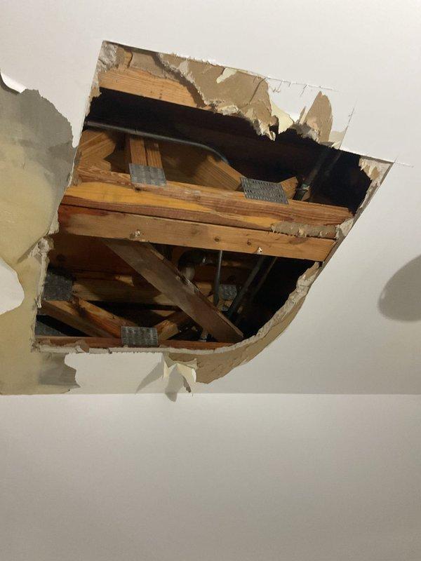 Responded to service request for bathroom plumbing issues. Upon inspection, discovered severe water damage in shower stall with extensive mold and mildew growth on walls and floor, indicating chronic moisture intrusion. Investigation revealed active leak from shower valve assembly that had migrated through ceiling below, causing significant structural damage to drywall and requiring emergency access opening to assess extent of water penetration into framing members. Replaced faulty shower control valve and associated trim components, addressed compromised waterproofing in tile installation, and coordinated necessary repairs to damaged ceiling structure and drywall restoration.
