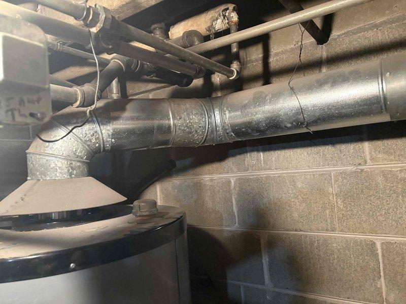 Responded to no hot water complaint with pilot light ignition failure on tanked water heater. Upon arrival, inspected gas-fired water heater unit in basement utility area and confirmed pilot light would not ignite. Performed diagnostic testing of thermocouple, gas control valve, and pilot assembly. Found faulty thermocouple preventing pilot flame detection and causing automatic gas shutoff. Replaced defective thermocouple with new component, cleaned pilot orifice and burner assembly of dust and debris accumulation. Re-established pilot light ignition, verified proper flame characteristics, and tested main burner operation through full heating cycle. Confirmed hot water restoration and proper temperature settings. Inspected all gas connections, water supply lines, pressure relief valve, and venting system for safe operation. Unit returned to full service with all safety systems functioning correctly.