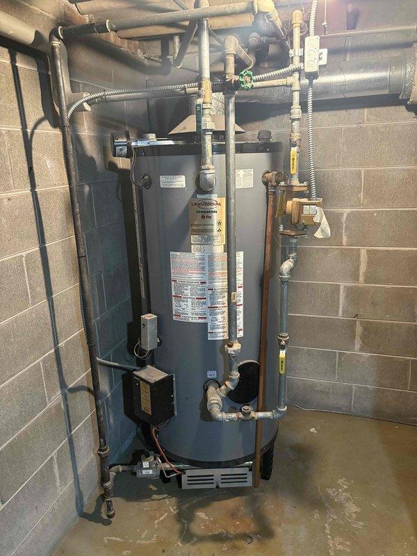 Responded to no hot water complaint with pilot light ignition failure on tanked water heater. Upon arrival, inspected gas-fired water heater unit in basement utility area and confirmed pilot light would not ignite. Performed diagnostic testing of thermocouple, gas control valve, and pilot assembly. Found faulty thermocouple preventing pilot flame detection and causing automatic gas shutoff. Replaced defective thermocouple with new component, cleaned pilot orifice and burner assembly of dust and debris accumulation. Re-established pilot light ignition, verified proper flame characteristics, and tested main burner operation through full heating cycle. Confirmed hot water restoration and proper temperature settings. Inspected all gas connections, water supply lines, pressure relief valve, and venting system for safe operation. Unit returned to full service with all safety systems functioning correctly.