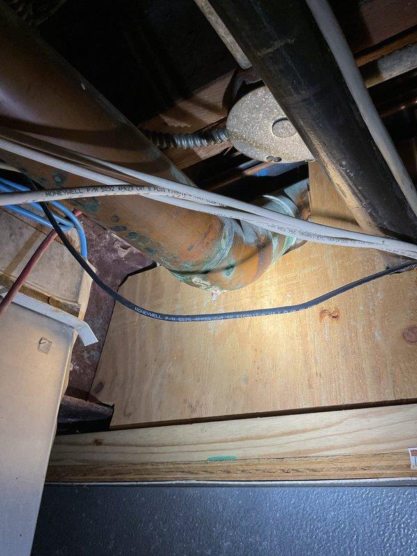 Responded to report of water leaking from toilets into basement area. Upon inspection, accessed crawl space and identified corroded cast iron waste pipe with visible rust deterioration and previous temporary repairs using black tape. The compromised pipe section showed significant moisture damage and structural degradation, indicating active leak allowing wastewater to escape into basement. Documented existing conditions including deteriorated piping, temporary patch attempts, and water damage patterns. Advised customer that affected section of waste line requires replacement to resolve leak and prevent further water intrusion and potential structural damage to basement area.