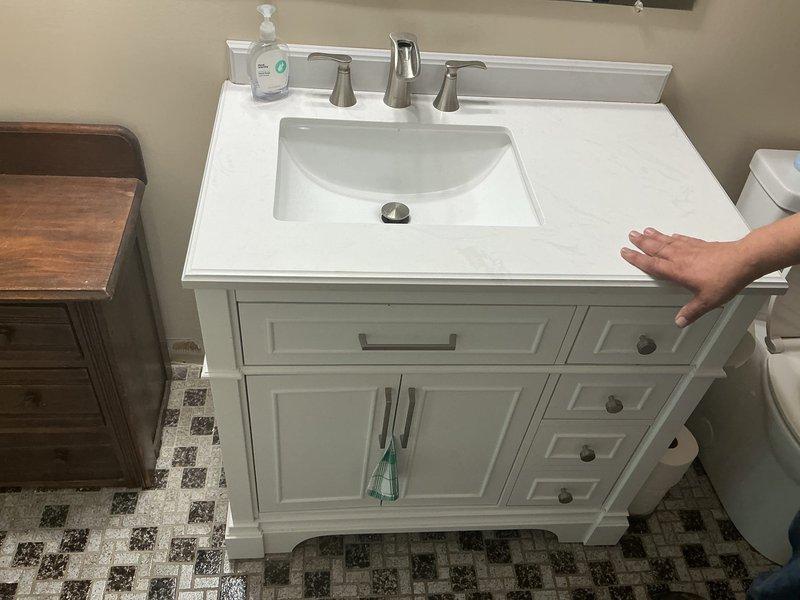 Replaced defective shut-off valves beneath bathroom vanity and successfully installed new double vanity unit with white cabinet, integrated undermount sink, and brushed nickel faucet fixtures. All water supply lines and drain assembly were properly connected, tested for leaks, and confirmed operational upon completion.