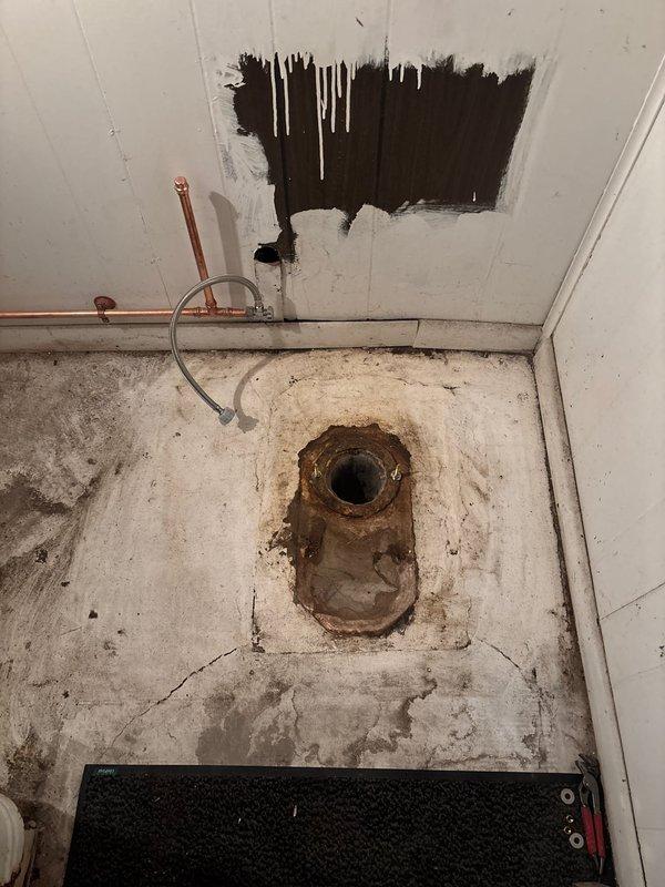 Responded to service call for plumbing assessment in basement utility area. Upon arrival, documented extensive water damage to ceiling with visible moisture infiltration and deterioration, along with severely corroded floor drain showing advanced rust deterioration on flange and mounting hardware. Evaluated copper supply line installation and flexible drainage connections for potential leak sources contributing to ongoing moisture issues requiring future remediation.