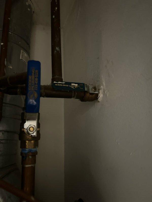 Responded to customer report of water damage in drywall below toilet, indicating potential wax ring failure. Upon inspection, removed toilet to access flange and confirmed deteriorated wax ring as source of leak. Replaced wax ring with new seal, inspected toilet flange for damage, and reinstalled toilet with proper bolting and alignment. Tested for leaks by flushing multiple times and verified no water seepage at base. Inspected visible plumbing connections including shut-off valve with blue handle and copper supply lines to ensure all connections were secure and functioning properly.