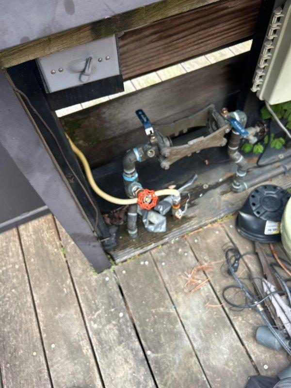Responded to request for outdoor spigot installation on existing rooftop water line. Accessed mechanical enclosure beneath wooden deck surface and connected new copper piping with green-handled valve control to existing plumbing system. Installed complete outdoor spigot assembly with proper shutoff capability. All connections secured and tested for leaks, ensuring proper water flow and operational functionality for exterior water access.