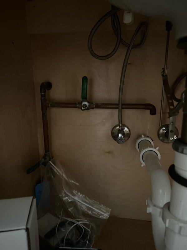 Responded to request for outdoor spigot installation on existing rooftop water line. Accessed mechanical enclosure beneath wooden deck surface and connected new copper piping with green-handled valve control to existing plumbing system. Installed complete outdoor spigot assembly with proper shutoff capability. All connections secured and tested for leaks, ensuring proper water flow and operational functionality for exterior water access.