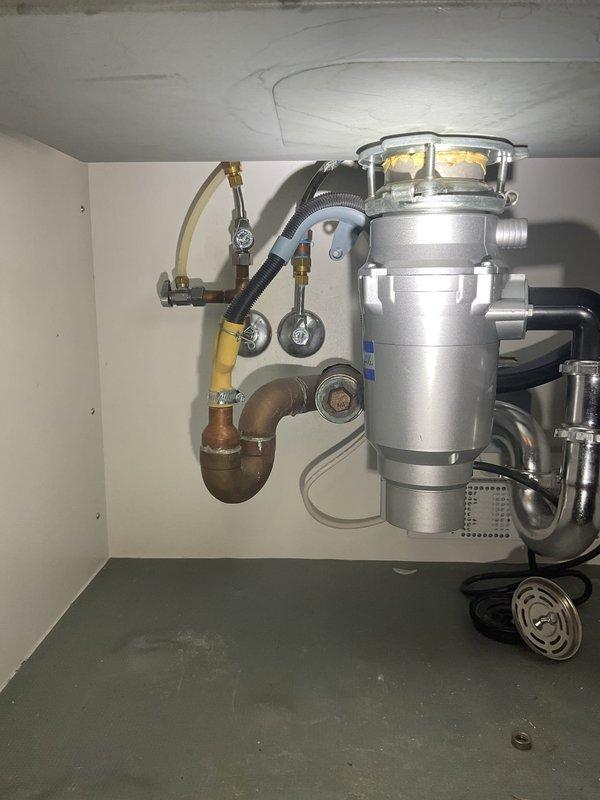 Responded to a kitchen sink leak that had been present for approximately three weeks, with water leaking onto the counter surface rather than beneath the sink. Successfully installed a new commercial-style pull-down kitchen faucet with spring coil neck and spray head functionality to resolve the leaking issue. Verified proper installation, tested all connections for leaks, and confirmed the garbage disposal and associated plumbing components beneath the sink remained properly connected and functional following the faucet replacement.