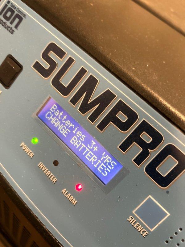 Performed routine maintenance on basement sump pump system in century-old home, including battery replacement for ION SUMPRO backup power unit. Upon inspection, existing battery was still functioning but replaced as preventive measure to ensure reliable operation during power outages. Verified system operation, tested alarm and power indicators, confirmed proper inverter function, and ensured all plumbing connections and PVC discharge piping with shutoff valves were secure and operational.