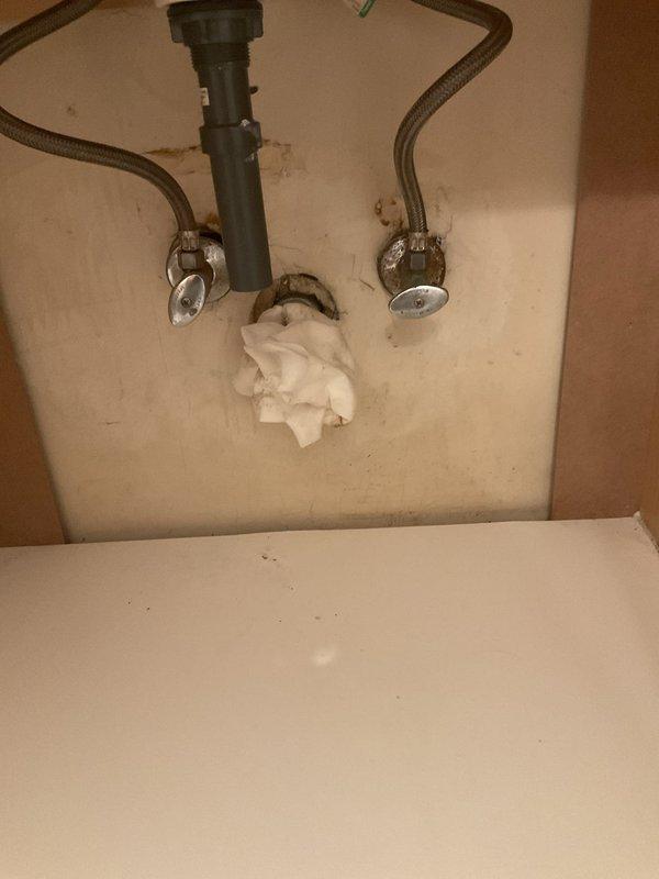 Responded to service call for slow-draining bathroom sink and tub. Upon inspection, accessed under-sink plumbing to assess drainage issue. Cleared obstruction from drain assembly, restoring proper water flow to both fixtures. Verified all connections were secure and tested drainage performance to ensure complete resolution.