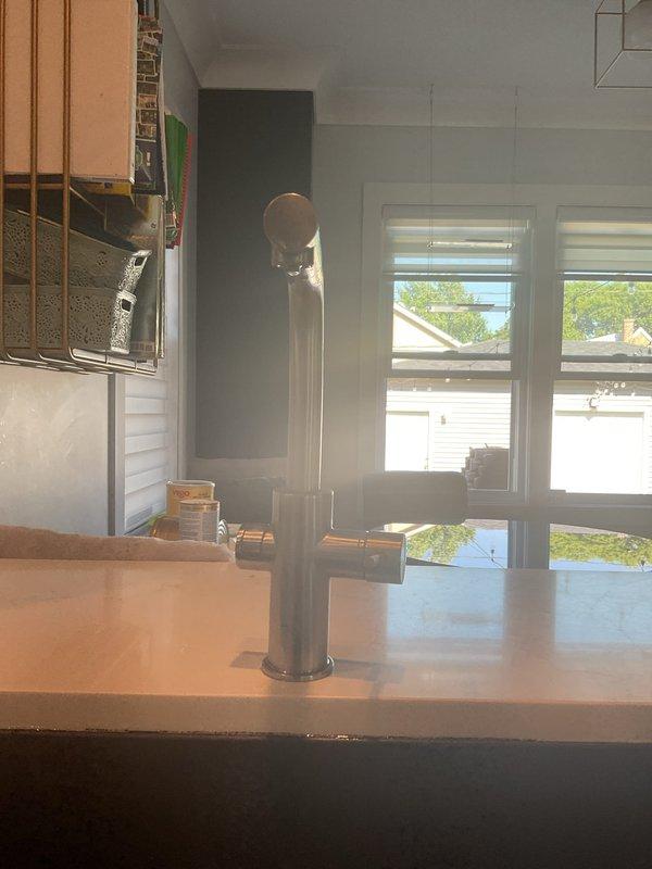 Replaced pull-down spray hose assembly on Grohe single-hole kitchen faucet. Accessed connections beneath sink, disconnected old spray hose from diverter assembly, installed new OEM replacement hose, and verified proper operation with no leaks detected at connection points.