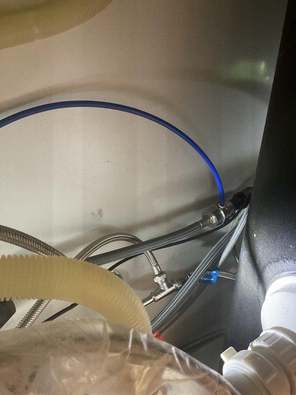 Replaced pull-down spray hose assembly on Grohe single-hole kitchen faucet. Accessed connections beneath sink, disconnected old spray hose from diverter assembly, installed new OEM replacement hose, and verified proper operation with no leaks detected at connection points.