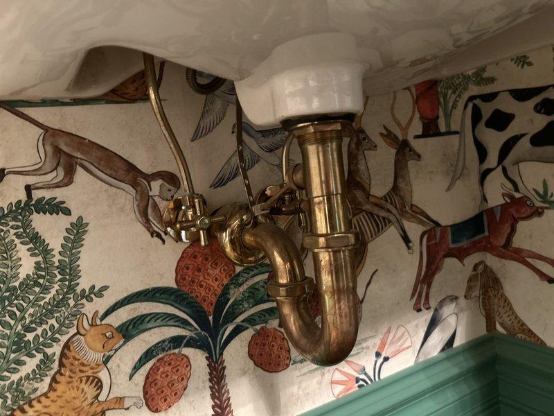 Completed standard plumbing maintenance inspection with no reported concerns. Inspected sump pump system in basement, confirming proper operation of pump motor, basin, and discharge piping. Verified all PVC connections, rubber couplings, and electrical wiring were secure and functioning correctly. Examined brass P-trap assembly and drain system beneath sink fixture, confirming proper drainage and no signs of leaks or deterioration. All plumbing components found to be in good working order with no immediate repairs required.