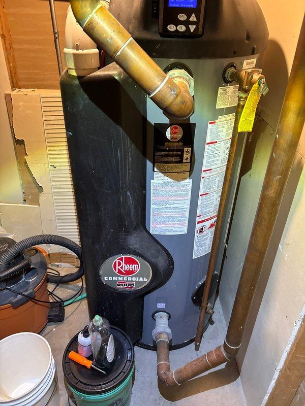 Responded to service call for Rheem Commercial RUUD tanked water heater displaying error code with no hot water production. Upon arrival, diagnosed the unit through digital control panel interface and visual inspection of all components. Evaluated copper supply and discharge piping connections, exhaust venting system, and electrical connections to the control board. Cleared error code from system, verified proper temperature settings on LCD display panel, and tested unit operation to confirm restoration of hot water service. All plumbing connections, gas lines, and safety devices inspected and confirmed to be functioning within manufacturer specifications.
