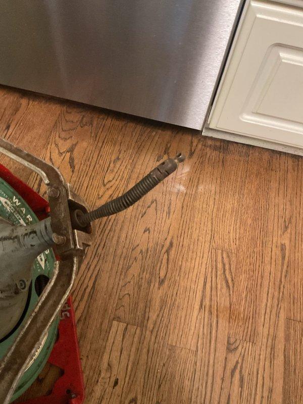 Responded to clogged kitchen sink in century-old home. Upon inspection, accessed cabinet beneath sink and identified blockage in drainage system. Cleared obstruction from P-trap and drain line, restoring proper water flow. Tested system to confirm complete drainage and verified all plumbing connections were secure with no leaks present.