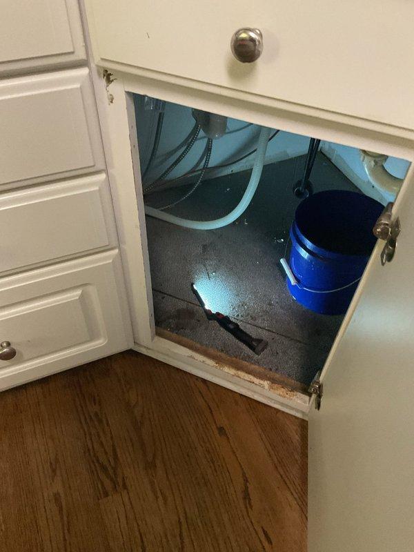 Responded to clogged kitchen sink in century-old home. Upon inspection, accessed cabinet beneath sink and identified blockage in drainage system. Cleared obstruction from P-trap and drain line, restoring proper water flow. Tested system to confirm complete drainage and verified all plumbing connections were secure with no leaks present.