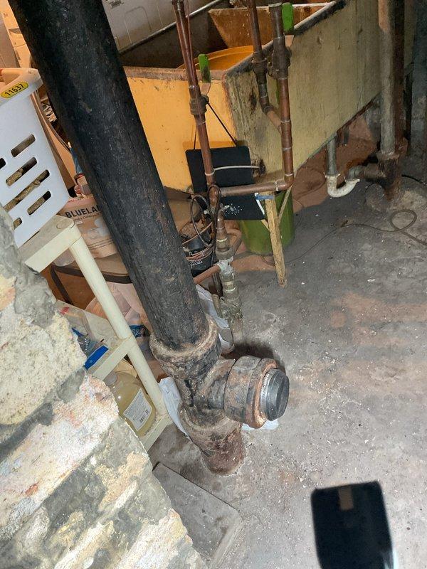 Performed routine preventative maintenance on residential sewer line via basement access point. Conducted thorough rodding of main drain line to clear any potential buildup and ensure proper flow. Upon inspection, found existing plumbing infrastructure showing signs of age with visible corrosion on cast iron pipe fittings and connections, though all components remained functional. Accessed cleanout located in concrete floor of basement utility area. Line cleared successfully with no obstructions encountered. System tested and confirmed flowing properly with no current drainage issues identified. Documented existing condition of aging plumbing components including heavily corroded pipe joints at base of main stack. All work completed as scheduled with tenant providing site access.