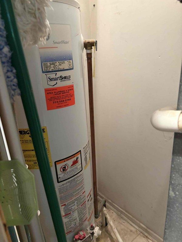Responded to a no hot water call and assessed a 10-year-old SmartWater tank-style water heater with active leaking. Upon inspection, confirmed the unit was inoperable and beyond economical repair due to tank failure. Documented the existing installation including copper supply piping with brass fittings and shutoff valves, and provided estimate for complete water heater replacement.