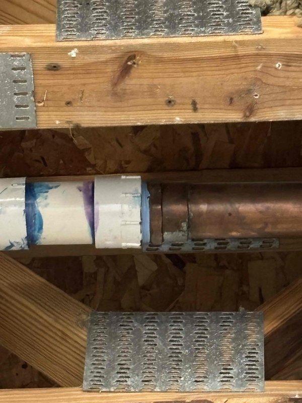 Responded to water leak investigation originating from ceiling in residential unit. Upon arrival, performed thorough inspection of ceiling cavity and structural framing to locate source of water intrusion. Removed sections of drywall and ceiling materials to access wooden joists, exposed plumbing lines, and mechanical systems. Located copper supply line and adjacent insulated ductwork running perpendicular through floor joists showing signs of moisture damage and discoloration. Identified leak source at pipe connection point within ceiling cavity. Documented all findings with photographic evidence showing exposed framing, compromised ceiling structure, and affected plumbing components for warranty records and future repair planning.