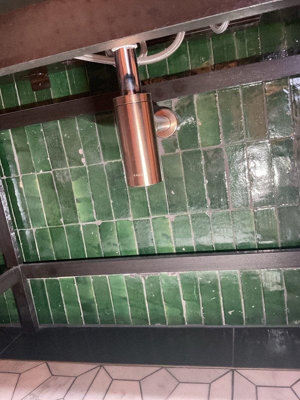 Responded to a clogged bathroom sink with backup issues and suspected drainage problems in the shower. Assessed both fixtures, documented existing conditions including standing water in the shower area, and performed drain clearing procedures to restore proper flow and drainage function in the affected bathroom plumbing system.