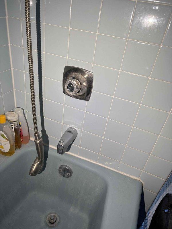 Responded to priority morning call for leaking shower faucet with broken handle in 50-year-old home. Diagnosed faulty cartridge in shower control valve, replaced worn cartridge assembly, tested operation to confirm proper function and verified leak was eliminated. Shut off water supply at basement valve during repair, restored full water pressure upon completion.