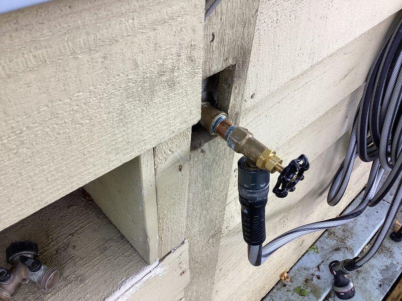 Replaced outdoor faucet assembly on exterior wall, installing new frost-free sillcock with shutoff valve and connecting to existing supply line. Removed old weathered fixture, secured new brass fitting to vertical trim post, and verified proper operation with no leaks detected upon testing.