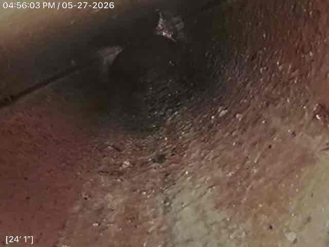 Conducted comprehensive drain and sewer system evaluation for residential property experiencing main line failure. Investigation revealed collapsed sewer pipe in street section in front of property. Documented crawlspace and underground access points with photographic evidence showing structural conditions and pipe routing. Provided detailed estimate for sewer line repair and replacement work required to restore proper wastewater conveyance from residence to municipal connection.