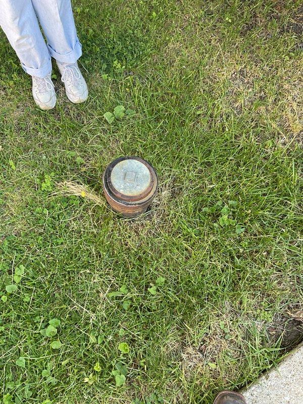 Responded to clogged kitchen sink backup issue. Upon arrival, investigated potential weather-related drainage problems due to recent heavy rainfall in the area. Inspected exterior cleanout access point in lawn area to assess main sewer line condition and determine if backup was caused by external drainage issues or internal plumbing obstruction. Documented cleanout location and condition for service records.