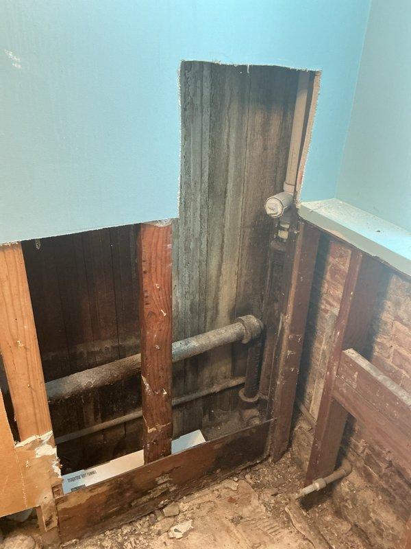 Responded to service call for catch basin repair due to rodent intrusion issue. Conducted thorough inspection of affected plumbing system, which required removal of interior wall sections to access concealed drainage infrastructure. Documented existing conditions including aged metal piping, PVC drainage lines, and compromised structural areas showing moisture damage and deterioration. Identified entry points where rodents were accessing the property through the compromised catch basin system. Photographed exposed plumbing configuration, pipe routing, and areas of concern including evidence of long-term moisture exposure and biological growth in utility areas. Provided estimate for catch basin repair and related remediation work to restore proper drainage function and eliminate pest access points.