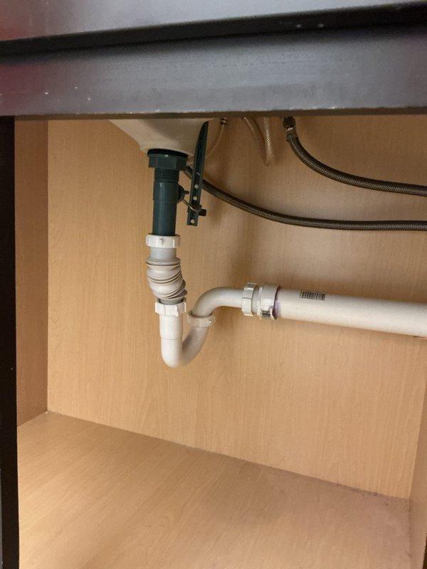 Responded to leaking faucet on double-sink vanity in main bathroom where water was escaping at the base connection point to the granite countertop during handle operation. Inspected undermount sink configuration with black faucet fixtures, tightened mounting hardware and base seal connections, and verified proper water supply line connections in cabinet below. Tested both hot and cold water operation through full range of motion with no further leakage detected at base or supply connections.