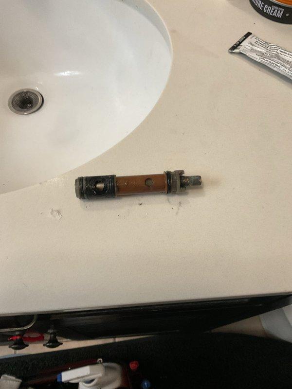 Responded to priority service call to address malfunctioning shower/tub valve system. Removed and replaced worn cartridge assembly showing significant mineral buildup and corrosion. Tested shower control valve and tub spout for proper operation following cartridge replacement to ensure complete restoration of water flow and temperature control functionality.