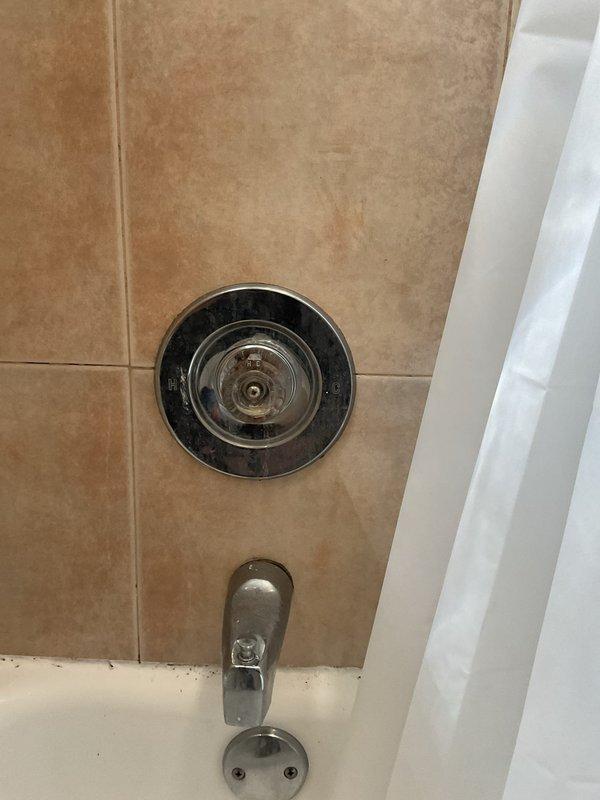 Responded to priority service call to address malfunctioning shower/tub valve system. Removed and replaced worn cartridge assembly showing significant mineral buildup and corrosion. Tested shower control valve and tub spout for proper operation following cartridge replacement to ensure complete restoration of water flow and temperature control functionality.