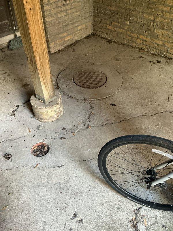 Responded to commercial property for clogged drain system in basement area. Upon arrival, located floor drain access point with standing water and active drainage issues. Inspected concrete drainage pit containing dark, stagnant water with visible bubbling, indicating blockage in the line. Performed drain cleaning procedures to clear obstruction and restore proper flow. Verified system functionality upon completion and documented conditions with photographic evidence of the drainage structure and surrounding work area.