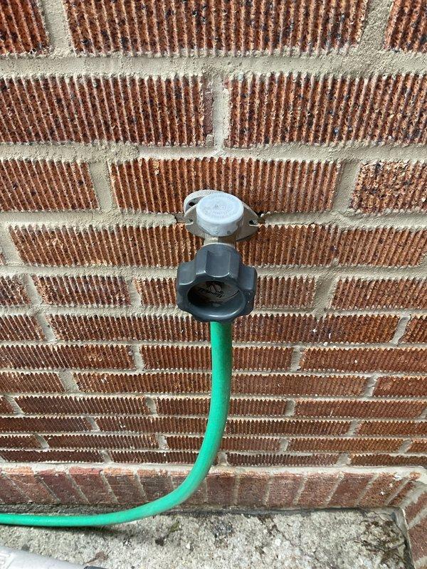 Responded to service call for assistance with two exterior water spigots requiring attention. Upon arrival, conducted thorough inspection of both outdoor hose bibs mounted on separate exterior walls. First spigot located on brick wall foundation with gray plastic fixture and white cap assembly. Second spigot positioned on significantly weathered horizontal wood siding showing extensive deterioration, peeling finish, and moisture damage. Evaluated both valve assemblies for proper operation, potential leaks, and freeze protection concerns. Documented existing conditions of mounting surfaces and fixture installations with photographic evidence. Assessed structural integrity of mounting locations, noting advanced wood deterioration on second spigot location requiring attention for proper fixture support. Provided professional assessment and prepared detailed estimate for necessary repairs or replacements to ensure reliable operation and prevent future water damage to building exteriors.