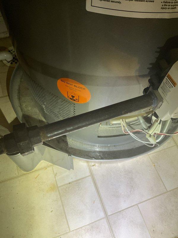 # Commercial Drain and Sewer Estimate

Conducted a comprehensive assessment of commercial water heater installation and drainage system. Documented existing water heater unit with proper ventilation clearances and warning labels intact. Verified presence of water alarm detection system installed at floor transition point between wood and tile surfaces to monitor potential water heater leaks or drainage issues. Photographed current plumbing connections, flexible supply lines, and drainage routing from appliance base. Evaluated floor conditions around water heater for signs of previous water damage or drainage concerns. Assessment included review of ventilation intake functionality and clearance requirements for combustion air supply. Prepared detailed photographic documentation of existing conditions to support drainage and sewer system estimate for commercial facility.