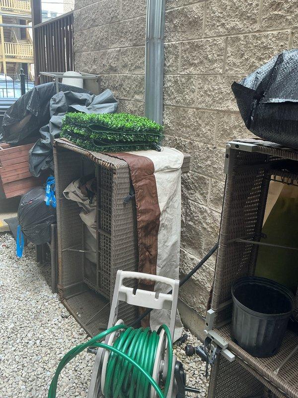 Conducted comprehensive site assessment for residential drain and sewer system issues. Evaluated downspout connection to main sewer line at building exterior, identifying potential drainage concerns where downspout discharge meets the underground system. Inspected mainline from rear to front of building to determine rodding requirements and assess blockage potential. Documented existing conditions with photographs showing downspout configuration, gravel drainage area, and connection points at building foundation for estimate preparation.